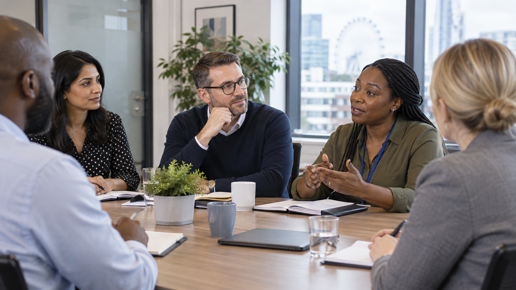 A diverse group of managers discussing respectful workplace standards in a meeting room